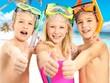 Foto FotoMural Happy children with thumbs-up gesture at beach