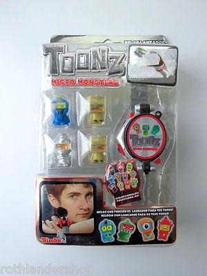 Foto reloj lanzador toonz. micro monsters. simba. nuevo