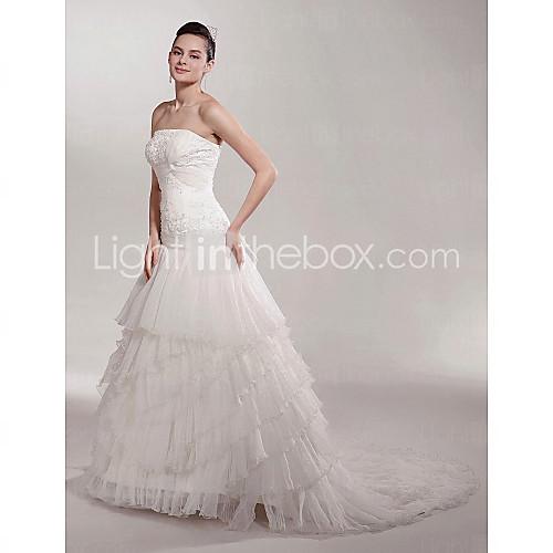 Foto una línea de tren satinado vestido de boda con gradas del organza corte strapless